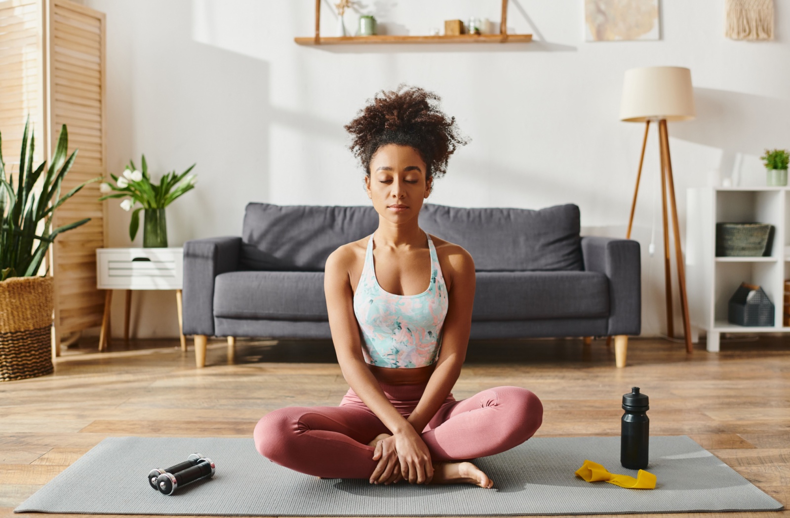 An adult practices yoga and mindfulness to help prevent caregiver burnout in their caregiving duties.