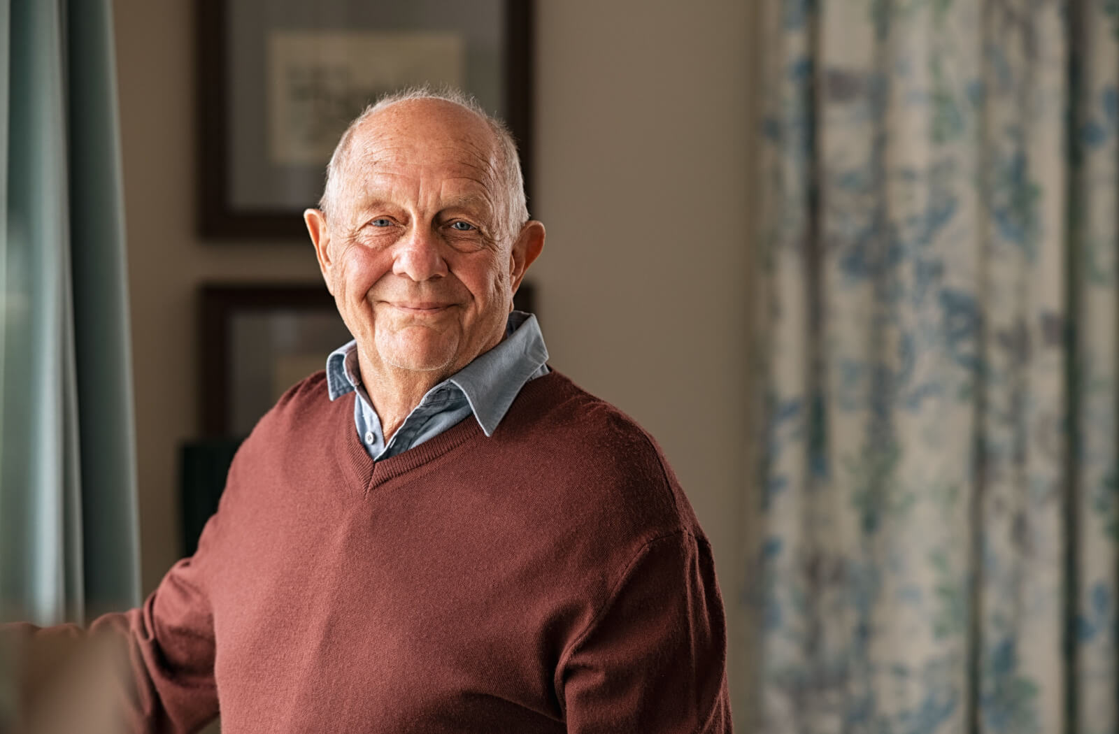 A senior man looking at the camera and smiling